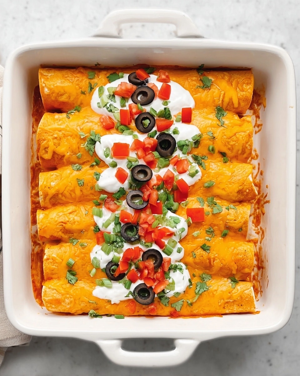 In a white rectangular baking dish with handles, there are seven rolled enchiladas covered in bright orange melted cheese, forming a single bottom layer. On top of the cheese, a line of white sour cream is spread across the center. Scattered over the sour cream are several black olive rings, small red diced tomatoes, and green chopped scallions and cilantro, adding color and texture to the dish. The baking dish sits on a white marbled surface, giving a clean and fresh look. Photo taken with an iphone --ar 4:5 --v 7