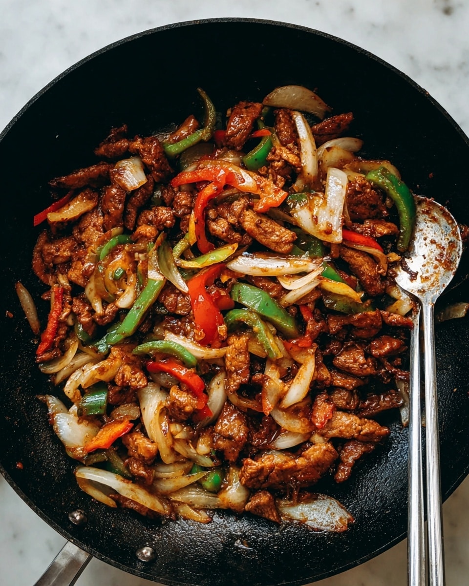 A pan full of cooked food shows three kinds of ingredients. The first layer is small brown pieces of cooked meat, covered with a shiny sauce. Among the meat are thick strips of cooked onions, white and slightly clear. There are also bright red and green bell pepper pieces that add color and freshness. The food covers the bottom of the black pan, with a pair of silver chopsticks resting on one side. The pan is on a white marbled surface. Photo taken with an iphone --ar 4:5 --v 7