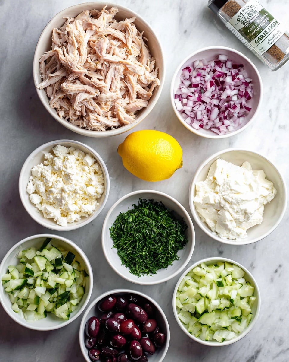 The image shows seven white bowls arranged on a white marbled surface with different ingredients. The top left bowl has a large amount of shredded light brown chicken. To the right of it is a smaller bowl filled with finely chopped red onions. Below the chicken bowl is a bowl with small crumbled white cheese, while to the right of this is a bowl with smooth, creamy white cheese. In the center of the bowls is a whole bright yellow lemon. Below the lemon, a bowl contains chopped green herbs, split equally between parsley and dill. To the right of the lemon is a bowl with dark purple chopped olives. The bottom bowl contains shredded pale green cucumber. A spice bottle labeled garlic powder is placed near the top right of the composition. photo taken with an iphone --ar 4:5 --v 7