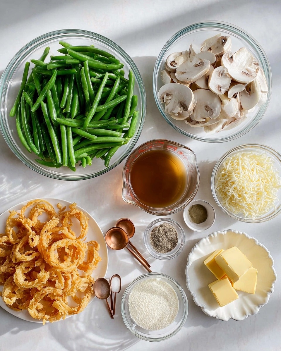 The image shows a flat lay of ingredients for a dish arranged neatly on a white marbled surface. There are nine clear and white bowls and plates, each holding different items: a large glass bowl with bright green cut green beans, a glass bowl with sliced white mushrooms, a small white bowl with finely minced garlic, another small white bowl filled with a white powder (flour), a small scalloped white bowl with shredded cheese, a small white bowl with light-colored round crumbs, and a small white plate with three yellow butter pieces. A glass measuring cup containing a brown liquid is at the center. Two copper spoons hold salt and black pepper. At the bottom left, a white bowl holds golden-brown crispy fried onion rings. The whole layout is clean and bright with natural light casting soft shadows, photo taken with an iphone --ar 4:5 --v 7