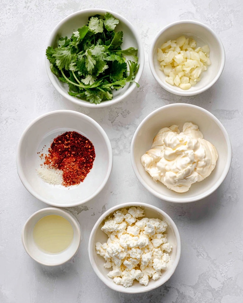 The image shows six small white bowls placed on a white marbled surface, each containing different ingredients. Starting from the top and moving clockwise, the first bowl holds fresh green cilantro leaves with visible stems. The next bowl contains finely chopped pale yellow garlic. Below that, a bowl has a mix of red chili powder and white salt, creating a contrasting red and white layer. Adjacent to it, another bowl holds a dollop of creamy off-white mayonnaise with a smooth texture. Next is a bowl with a pale yellow liquid, possibly lime juice. Finally, the last bowl contains crumbled white cheese with a soft and slightly crumbly texture. The arrangement is neat and clear, with each bowl distinct and ingredients easy to identify. Photo taken with an iphone --ar 4:5 --v 7