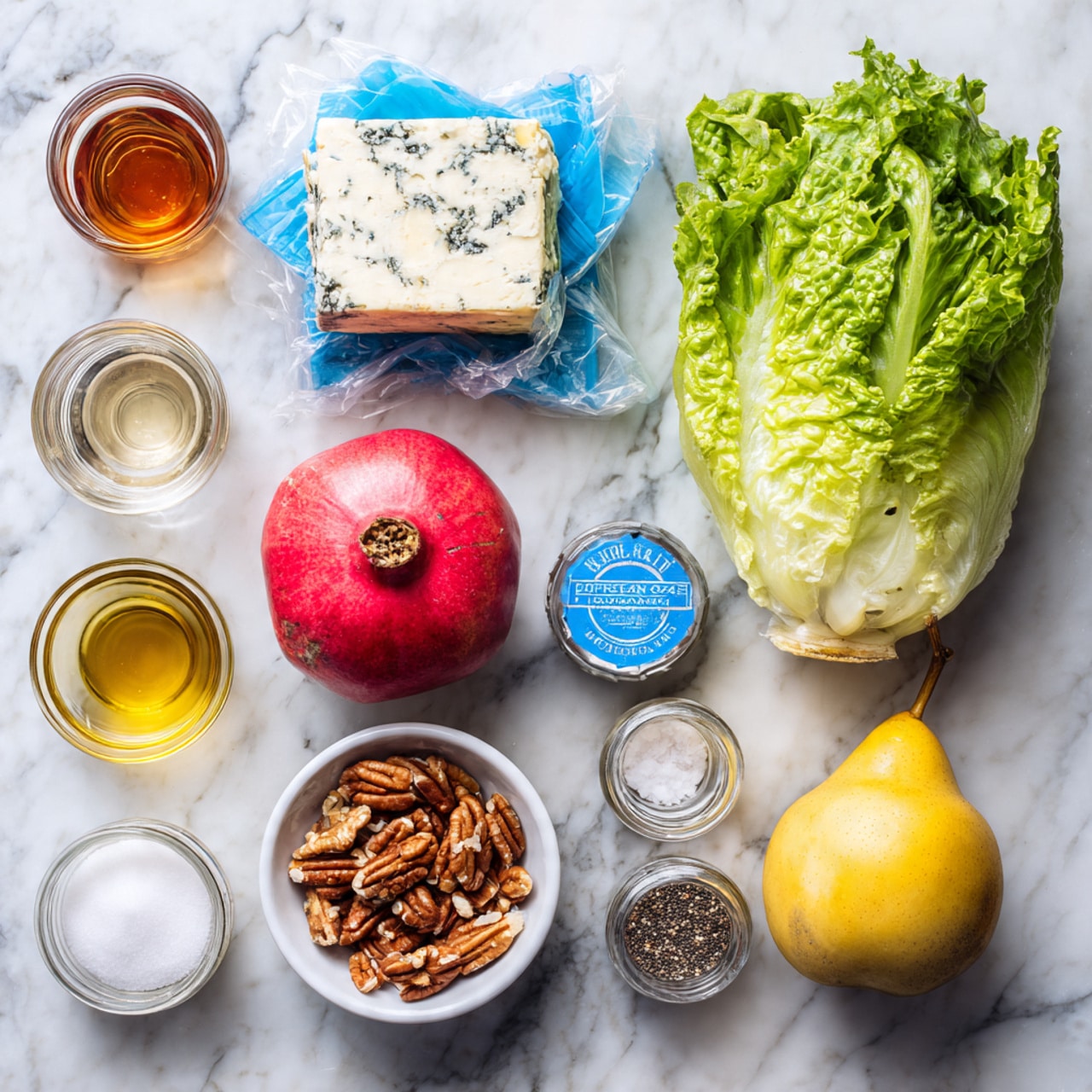 The image shows a top view of various fresh ingredients arranged neatly on a white marbled surface. On the right side, there is a bunch of green romaine lettuce with a blue label around it and a yellow pear next to it. In the middle, there is a whole pomegranate with a vibrant red color, a block of Swiss cheese wrapped partially in blue and white plastic, and a small white bowl of pecans. Surrounding these are glass containers holding a dark amber liquid, clear oil, white sugar, minced onions, and a small spice jar with poppy seeds. Each item is spaced out clearly and looks fresh and ready to be used. photo taken with an iphone --ar 4:5 --v 7