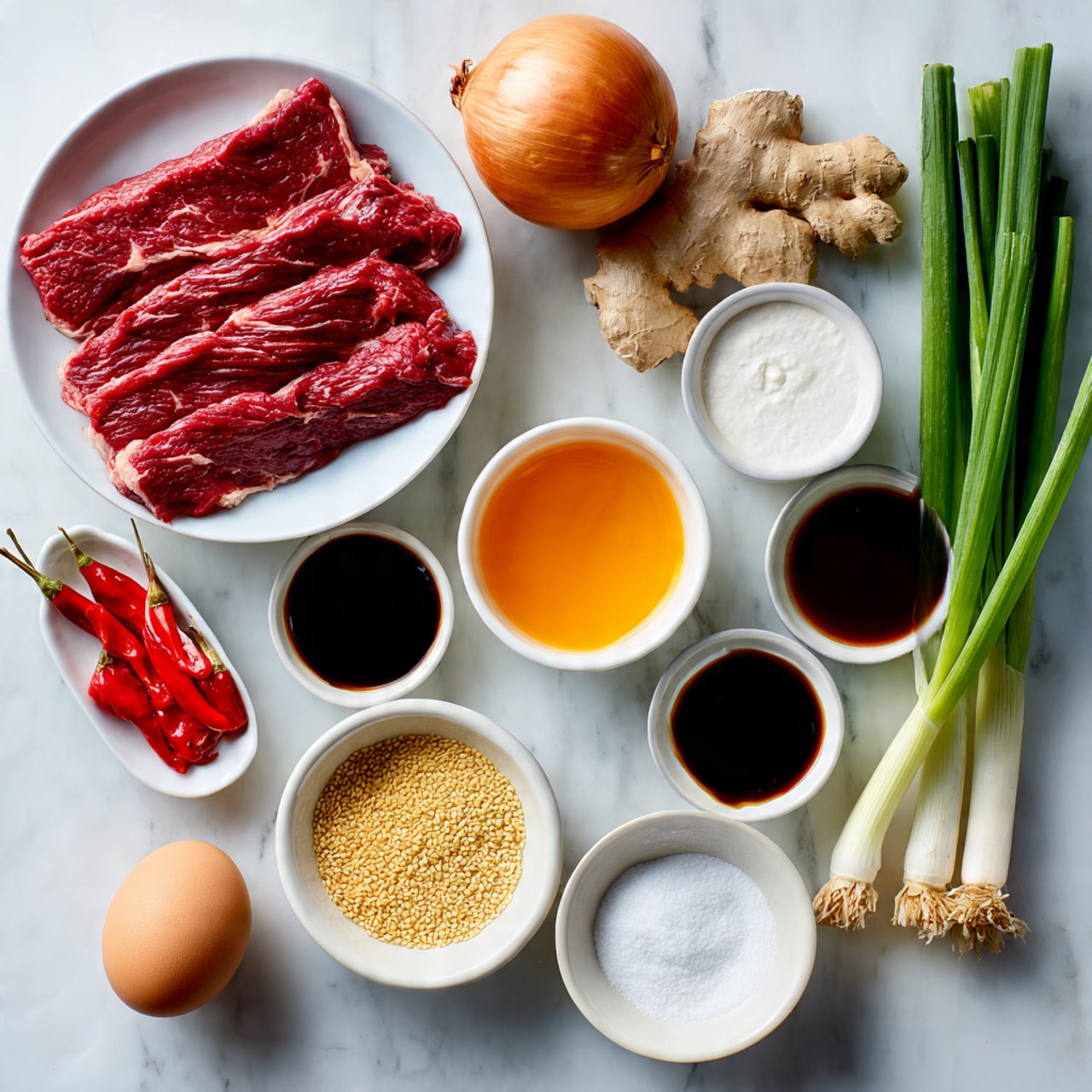 The image shows several ingredients neatly arranged on a white marbled surface. There is one layer of thin strips of raw red steak on a white bowl at the top left. Around it, there are whole and small items including a brown onion, a piece of ginger root, and three pieces of garlic cloves grouped near the top right. Small white bowls contain white pepper powder, rice vinegar, sweet chili sauce, soy sauce, sugar, and cornflour or cornstarch, each with distinct colors and textures, ranging from bright orange-red sweet chili sauce to dark brown soy sauce and white powders. Below these bowls, two bright red chilies lie next to a small white bowl of tan sesame seeds. To the right, a single whole brown egg sits near two long green spring onions or scallions. The items are spread out in an organized fashion with clear space between them and each item is labeled with black text. Photo taken with an iphone --ar 4:5 --v 7