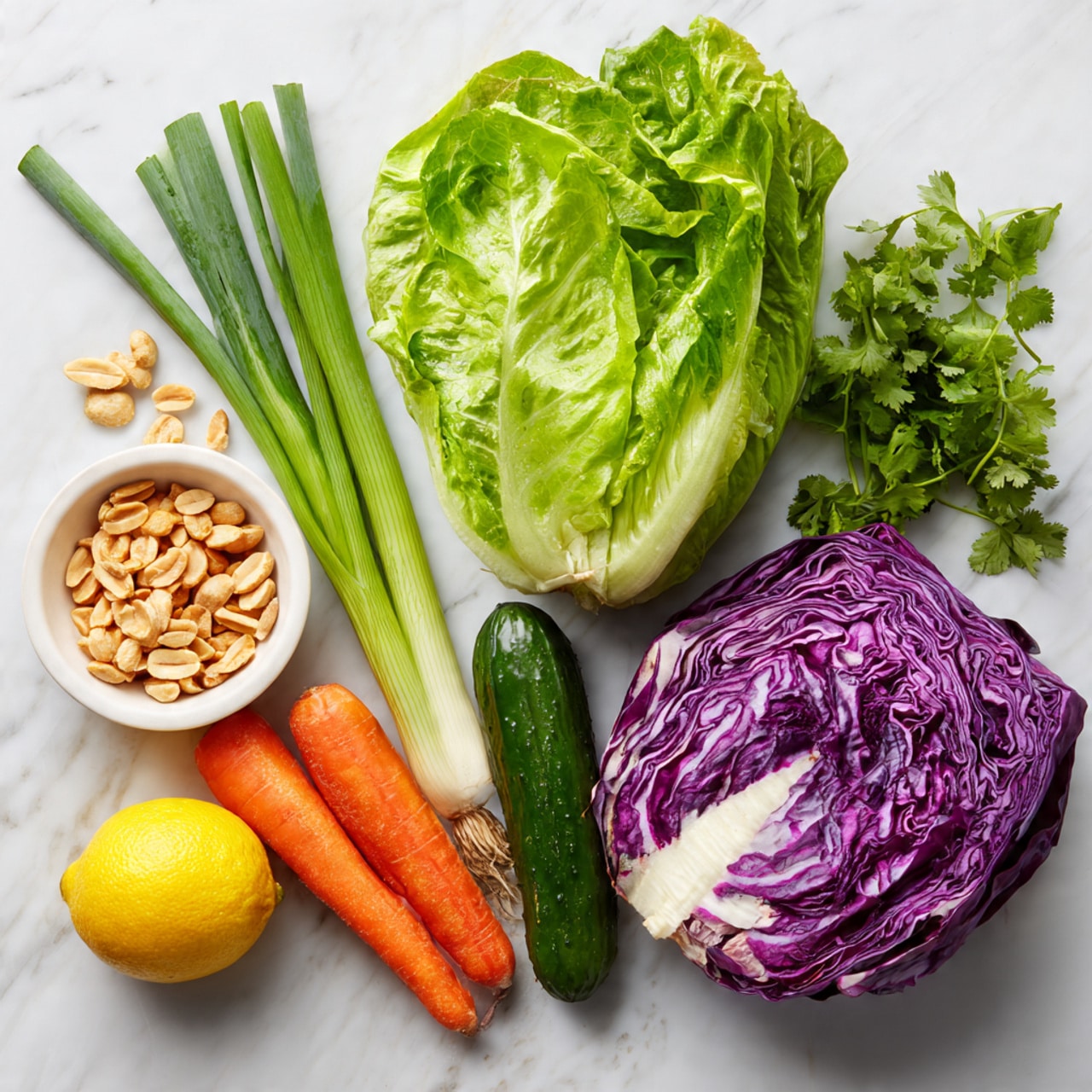 The image shows fresh raw ingredients laid out on a white marbled surface. There is one large green leafy romaine lettuce at the top, three long green onions below it, and a small white round bowl filled with chopped peanuts to the left side. Next to the bowl, there is a whole pale yellow lemon, some green cilantro leaves near the bottom left, a long orange carrot horizontally placed in the middle, a dark green cucumber below the carrot, and a half of a vibrant purple-red cabbage with white veins on the right side. The colors are bright and fresh, highlighting the textures of each vegetable and nut, with no dish prepared yet. Photo taken with an iphone --ar 4:5 --v 7