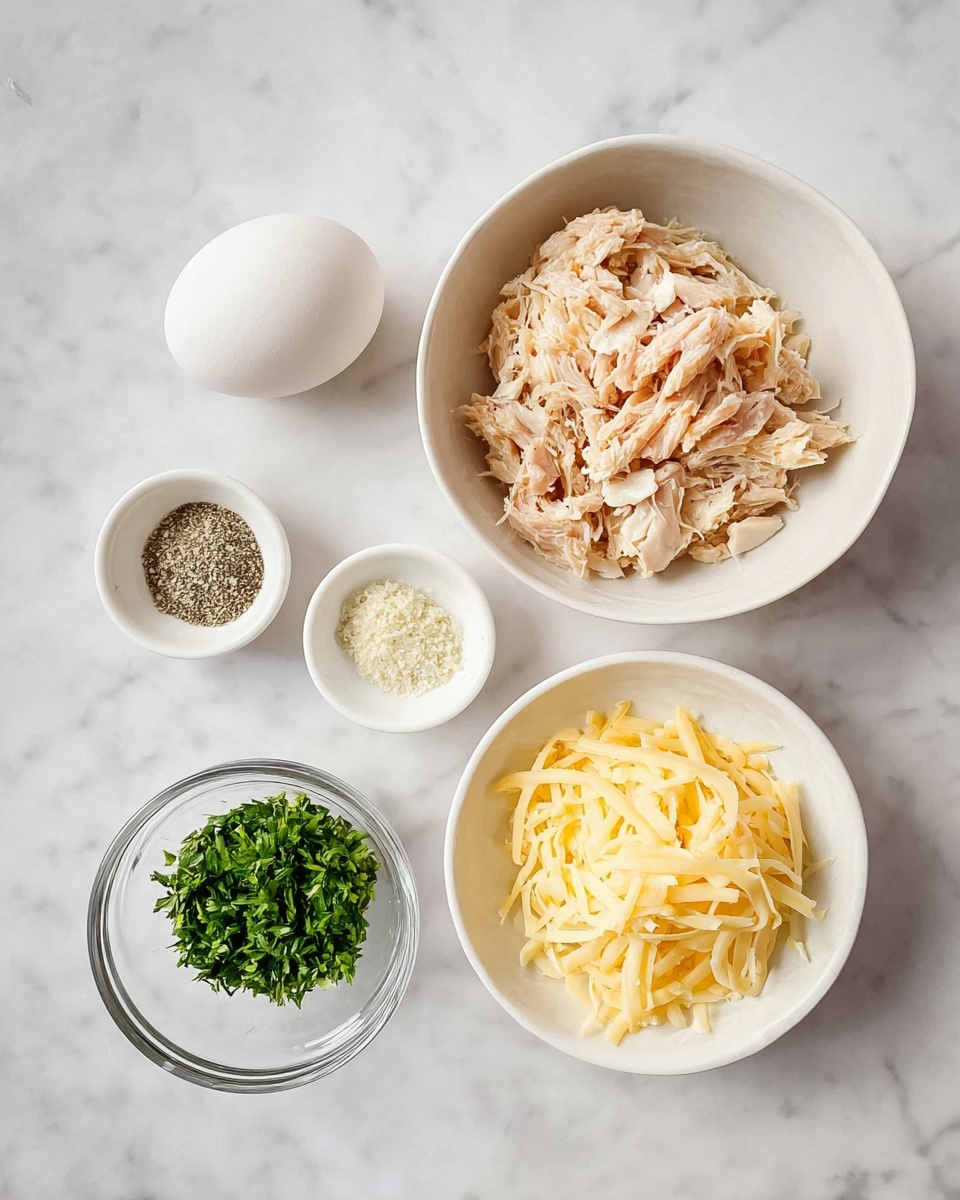 The image shows five small bowls and an egg on a white marbled surface. The largest white bowl at the top right contains shredded light pink chicken pieces mixed with white bits. Below it to the right, another white bowl holds a pile of yellow shredded cheese with soft texture. At the bottom left is a small clear glass bowl filled with chopped bright green herbs. To the left of the chicken bowl is a small white bowl with piles of black pepper, pale yellow seasoning, and white salt. Above this bowl and to the left is a plain white egg resting on the marble surface. The arrangement forms a rough square shape, all ingredients clearly visible and well-lit. Photo taken with an iphone --ar 4:5 --v 7