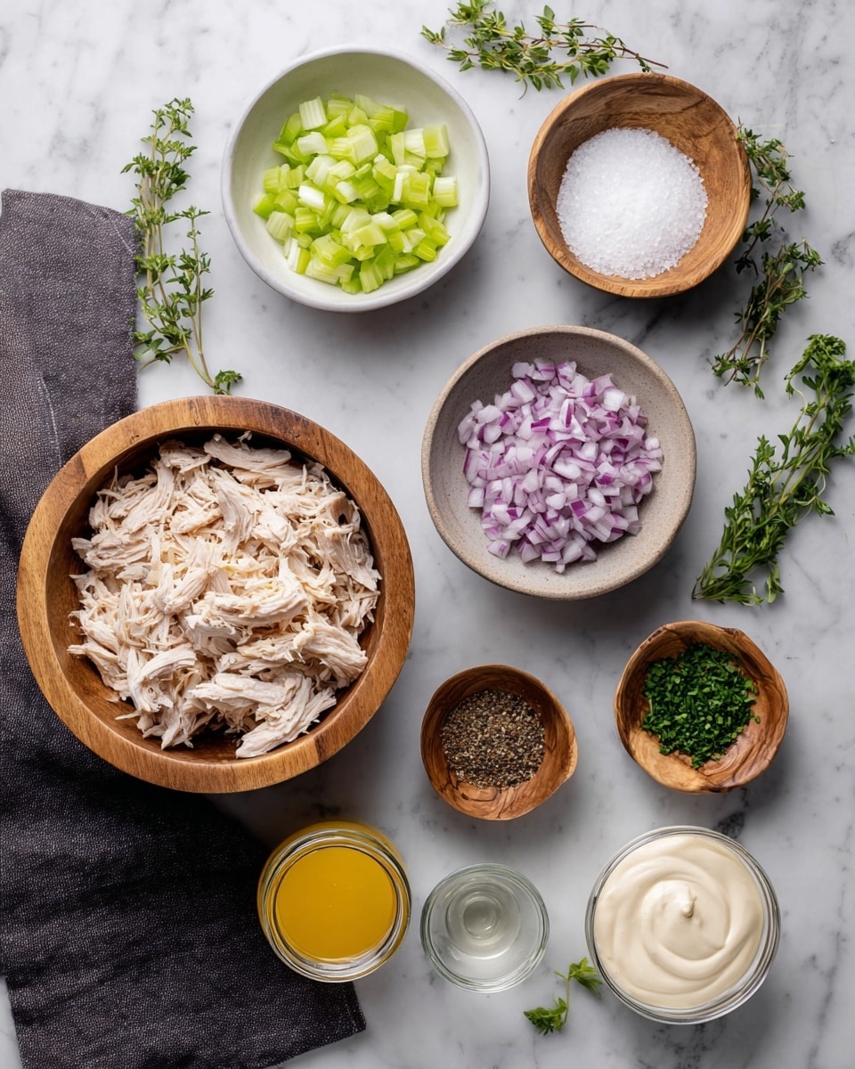 The image shows several small white bowls and wooden bowls arranged on a white marbled surface. A large wooden bowl is filled with shredded pale beige cooked chicken pieces placed near the bottom left. Above it, a white bowl contains chopped light green celery pieces, and next to it, a wooden bowl holds coarse white salt. To the right, another white bowl is filled with chopped purple and white onions. Below the onion bowl, a wooden bowl contains black pepper, and beside it, another wooden bowl holds finely chopped green herbs. Near the bottom center, a small glass jar has yellow mustard, and next to it, a white bowl is filled with creamy white mayonnaise. A small glass with a clear liquid is also placed near the center. Fresh green herb sprigs lay on the marbled surface on both sides, and a folded dark gray cloth is on the lower left corner. Photo taken with an iphone --ar 4:5 --v 7
