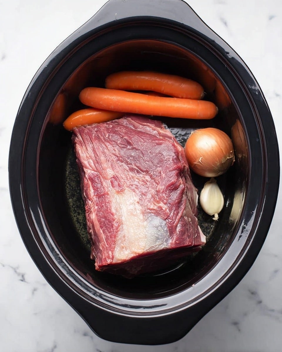 A large piece of raw red meat with some white fat on top lies in the center of a black slow cooker. Around the meat, there are three whole orange carrots placed on the left side, a whole brown onion at the right, and two whole cloves of pale garlic near the bottom. The inside of the slow cooker is dark and smooth, while the surface under the cooker is white with a marbled pattern. photo taken with an iphone --ar 4:5 --v 7