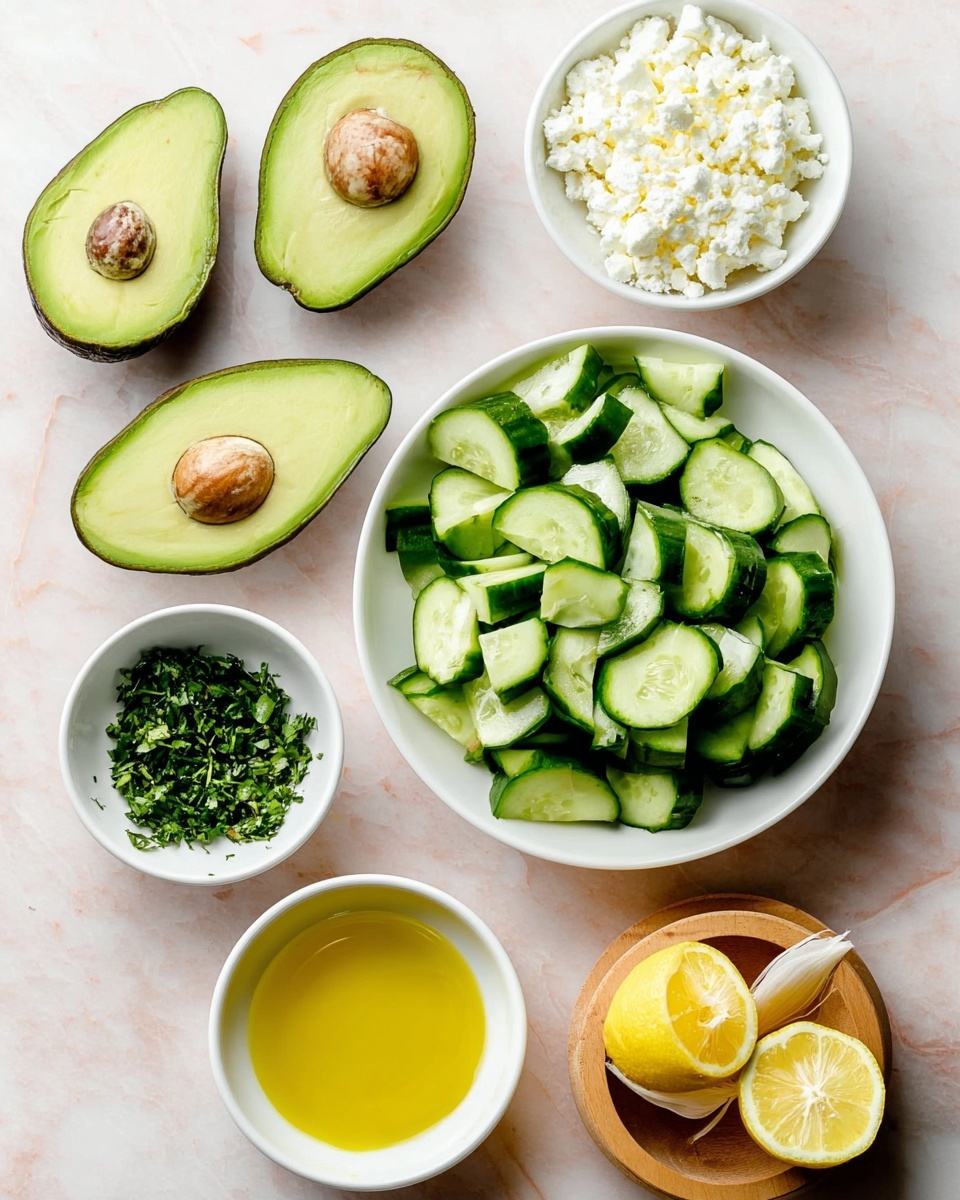The image shows ingredients arranged on a white marbled surface. There are four avocado halves with bright green flesh and a dark brown seed in two of them, placed on the left side. In the center, there is a white bowl filled with thick, green cucumber slices. Above the bowl, a smaller white bowl holds crumbly white cheese. Below to the left, another small white bowl contains finely chopped green herbs, while next to it is a bowl of golden yellow olive oil. To the right, there is a squeezed lemon half sitting on a wooden citrus reamer, with another lemon half nearby showing its juiced inside. The colors are fresh and vibrant, and the arrangement is neat and simple, showing the freshness of the ingredients. photo taken with an iphone --ar 4:5 --v 7