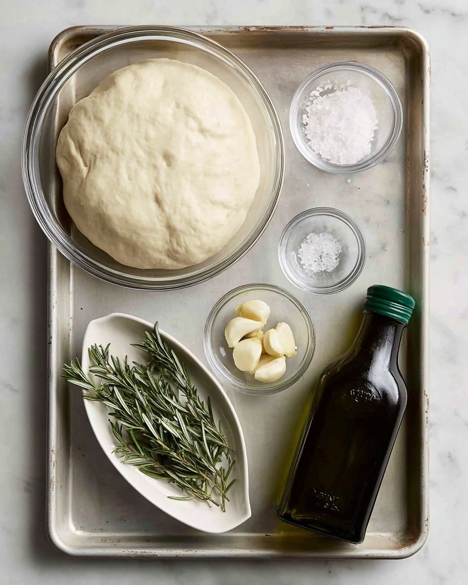 A metal baking tray holds five items on a white marbled surface: a large clear glass bowl in the upper left filled with smooth, pale dough that has risen with a slightly uneven surface; a small clear glass bowl in the upper right containing coarse white salt; a small clear glass bowl in the center with several peeled garlic cloves; a small white oval dish in the lower left with several fresh green rosemary sprigs; and a dark green plastic bottle of olive oil with a green cap in the lower right. All items are neatly arranged on the tray. Photo taken with an iphone --ar 4:5 --v 7