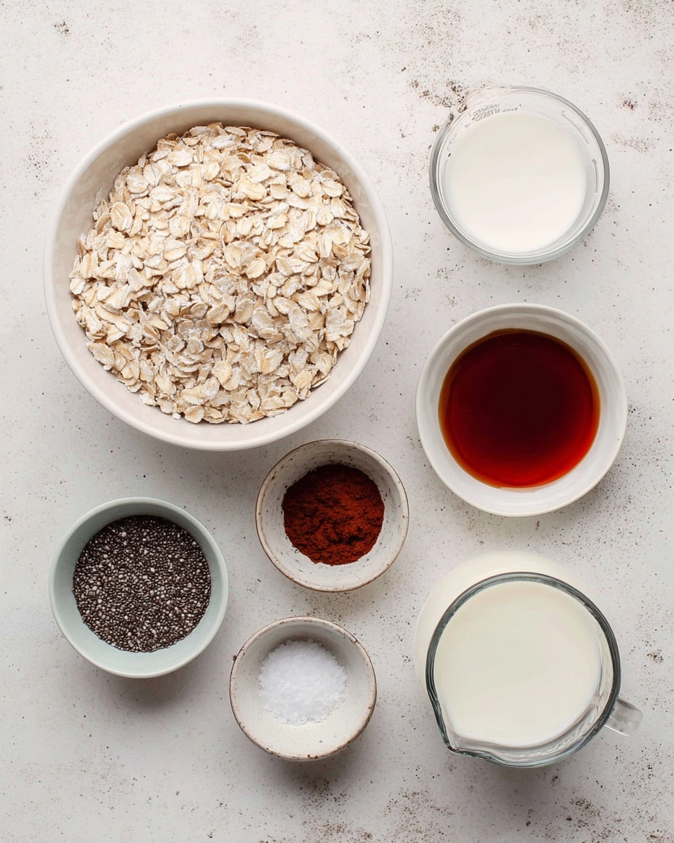 A white bowl filled with light tan rolled oats sits on a white marbled surface surrounded by small white bowls and a glass measuring cup. The bowls contain dark brown cocoa powder, black chia seeds, smooth white yogurt, a dark reddish syrup, dark brown vanilla extract, and coarse white salt. The glass measuring cup holds white milk. Each ingredient is clearly visible with smooth and rough textures in a neat flat lay arrangement. Photo taken with an iphone --ar 4:5 --v 7