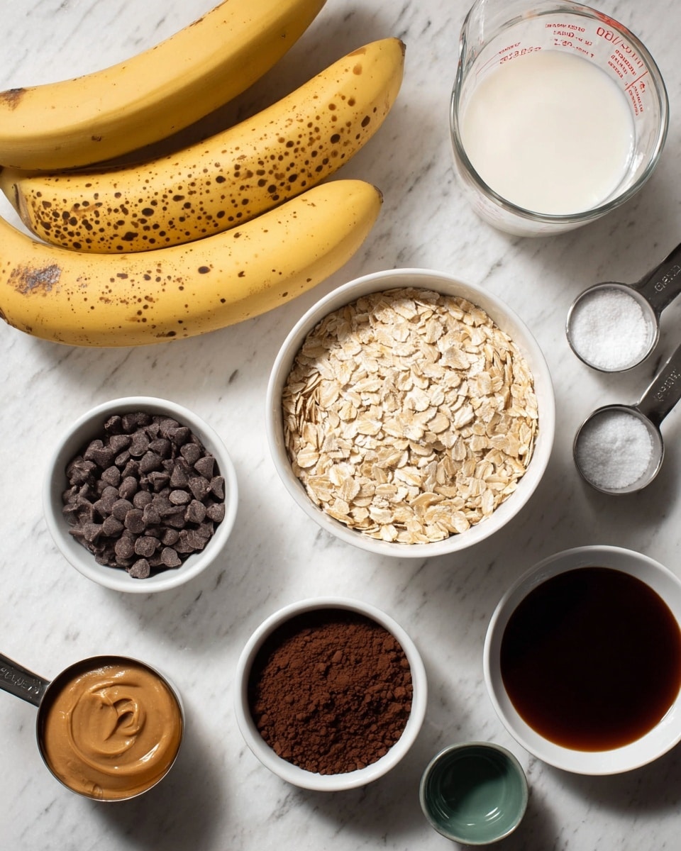 The image shows a white marbled surface with various ingredients arranged neatly. In the center is a medium white bowl filled with light beige oats. Behind it are two ripe bananas with brown spots. To the right, there is a clear glass measuring cup with white liquid, and below it a small white bowl filled with dark chocolate chips. In the middle foreground, there is another small white bowl holding dark brown cocoa powder. At the bottom right, a white bowl contains a dark brown liquid, likely coffee or syrup, while in the bottom center is a tiny green dish with a small amount of dark liquid. On the left side, near the bottom, is a metal cup filled with smooth light brown peanut butter and two metal measuring spoons with white powder, possibly salt and baking soda. Photo taken with an iphone --ar 4:5 --v 7
