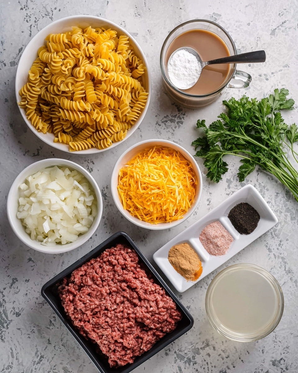 The image shows several ingredients arranged on a white marbled surface. There is a white bowl near the top left filled with yellow spiral pasta, with a metal spoon holding white powder placed on top. Below it, a metal measuring cup holds bright orange shredded cheese and two cloves of garlic resting on the side. Next to that, a white bowl is filled with finely chopped white onions. Towards the bottom left is a black tray holding raw ground meat with clear rows visible. Near the center right, a small white dish holds four sectioned spices or powders in red, pink, black, and beige colors. Behind this dish, a clear glass mug contains a light brown liquid, and fresh green parsley lies next to it. A transparent glass filled with white liquid sits on the bottom right. The photo was taken with an iphone --ar 4:5 --v 7