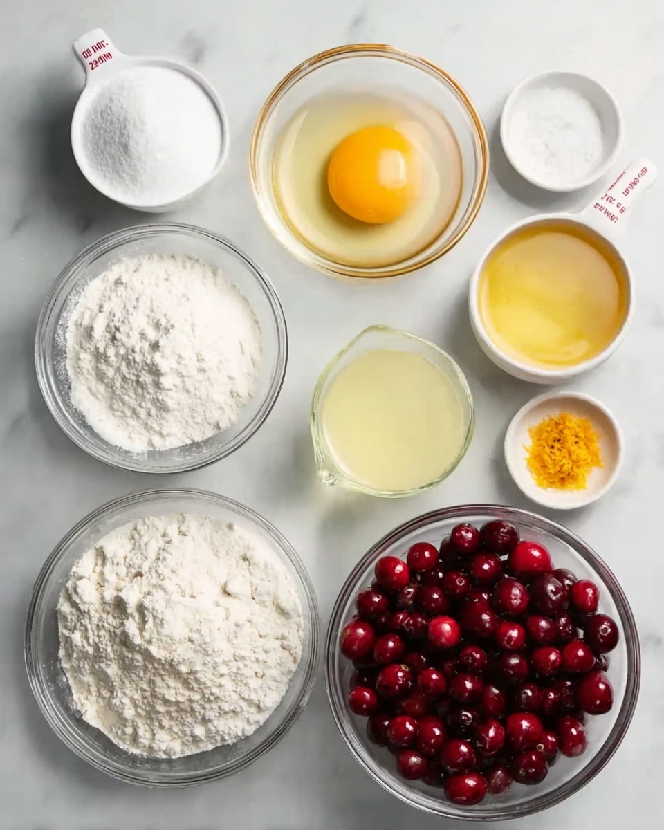 A white marbled surface holds eight clear glass bowls and two white measuring cups arranged neatly; starting from the top left, a white measuring cup is filled with white powdery sugar, next to it is a round bowl with a raw egg showing a bright yellow yolk and clear egg white, to the right is a bowl full of shiny red cranberries. Below, from left to right, a large bowl contains white flour with small white baking powder pieces, beside it a bowl of white granulated sugar, above this a white measuring cup holds pale yellow liquid, to the right a small bowl with orange zest atop a white powder, and finally a bowl with a golden-yellow liquid, all on the white marbled surface photo taken with an iphone --ar 4:5 --v 7