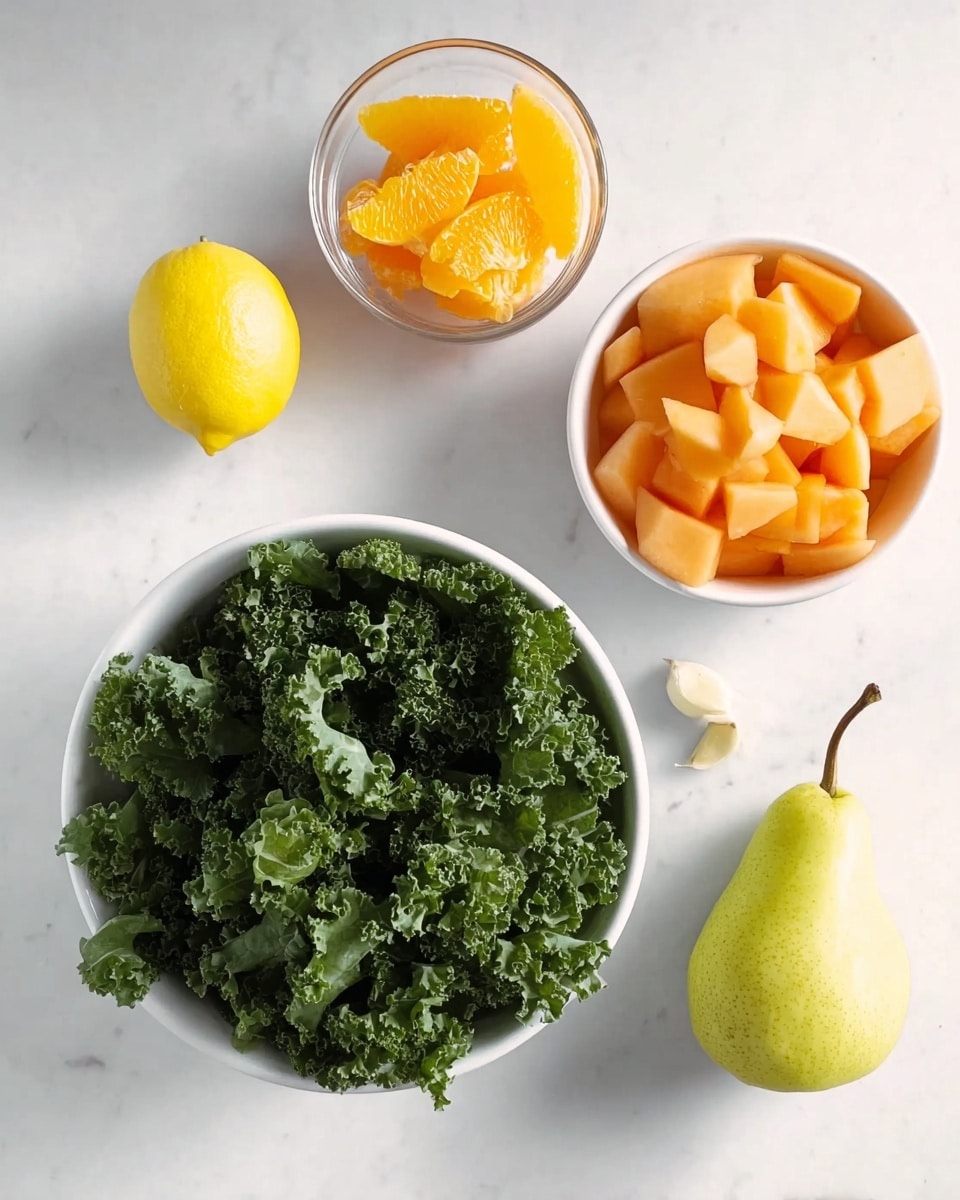 The image shows a white bowl in the center filled with dark green curly kale leaves, creating a textured, leafy layer. To the right of the bowl, there is another white bowl containing chopped pale orange cantaloupe pieces arranged loosely. On the left side, there is a small glass bowl filled with sliced light orange fruit slices. Above the central bowl is a whole bright yellow lemon with a shiny surface, and below it lies a light green pear with a brown stem. Near the pear, there is a small white piece of garlic. All items are placed on a white marbled surface, creating a clean and fresh setting. Photo taken with an iphone --ar 4:5 --v 7