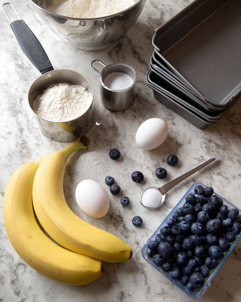 The image shows baking ingredients laid out on a white marbled surface. There are two ripe bananas placed near the bottom left corner, with a metal measuring cup filled with flour and another metal cup with sugar placed above them. Two white eggs are positioned near the middle right side, close to a small metal spoon with a pinch of salt inside. Scattered around are several fresh blueberries, with a clear plastic container of blueberries on the right edge. In the background, there are three metal loaf pans stacked on each other and a large silver mixing bowl partially visible in the top left area. The lighting is natural, showing clear textures of the ingredients and metal tools. photo taken with an iphone --ar 4:5 --v 7