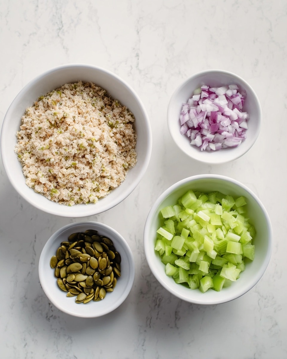 Four white bowls sit on a white marbled surface. The largest bowl on the left holds a light beige crumbly mixture with small bits of darker pieces throughout. To its right and slightly above is a small bowl filled with shiny olive green pumpkin seeds. Below this is another small bowl containing finely chopped purple onions with white pieces. On the far right, a large bowl contains chopped light to medium green celery pieces. The bowls are arranged neatly with space in between photo taken with an iphone --ar 4:5 --v 7