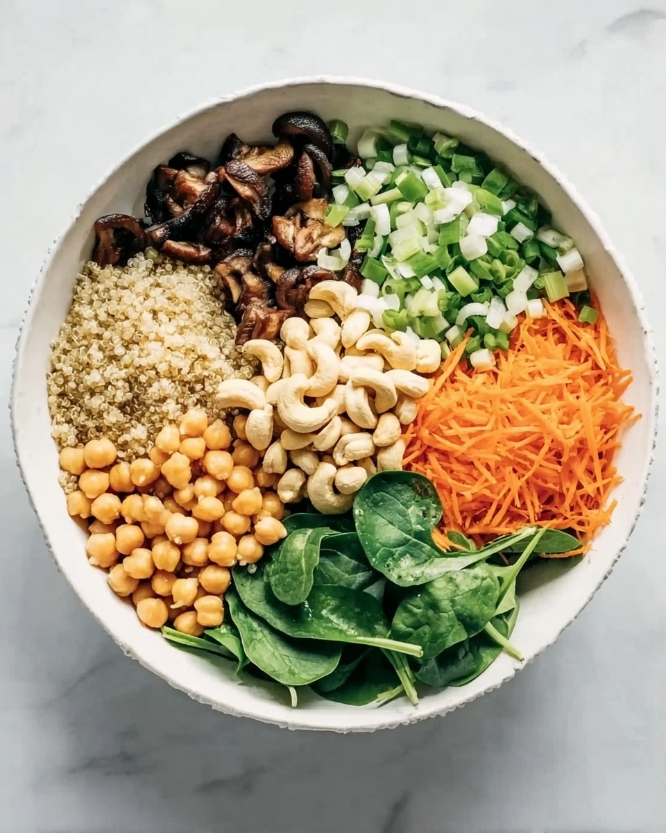 A white round bowl with six different layers arranged in separate sections forming a colorful pattern. Starting from the top and moving clockwise: dark brown cooked mushrooms with a soft texture, beige fluffy quinoa grains, thinly sliced green onions with white and light green rings, round light brown chickpeas, fresh bright green spinach leaves, and finely shredded bright orange carrots. In the center, a pile of pale cashew nuts is placed, acting as a focal point. The bowl sits on a white marbled surface, creating a clean and fresh look. Photo taken with an iphone --ar 4:5 --v 7