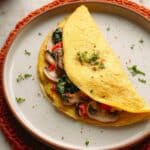 Chickpea Omelette with Sautéed Vegetables, Avocado, and Tempeh Bacon Recipe