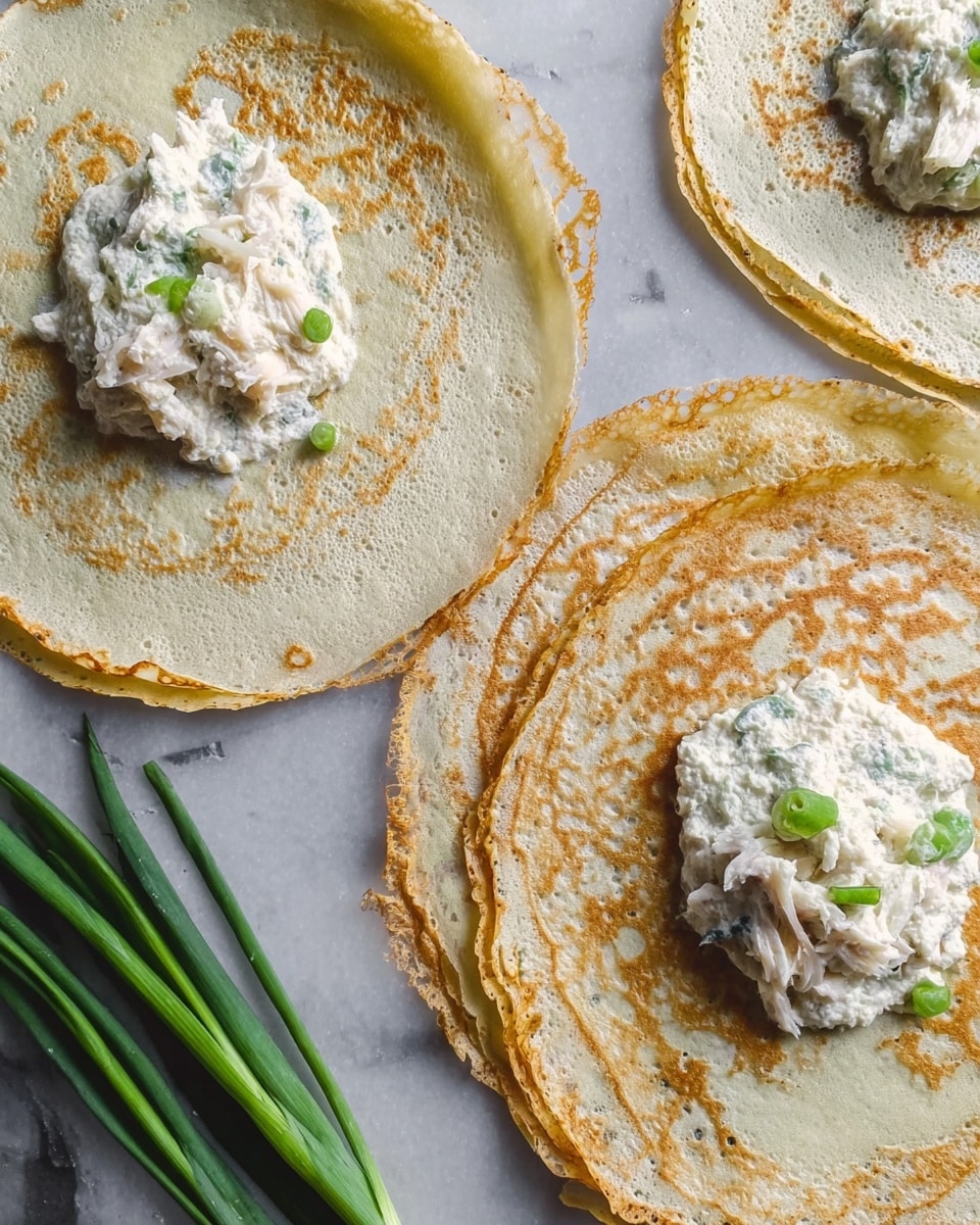 The image shows three thin crepes placed on a white marbled surface, each with a small mound of white shredded filling mixed with small bits of green placed near the center of each crepe. The crepes have crispy, lightly browned edges that look delicate and thin, with slightly uneven circular shapes. On the surface near the bottom left, three long, green onions lay next to the crepes, adding a fresh contrast in color. The light shines softly on the crepes, highlighting their texture and the contrast between the pale crepe and the filling. photo taken with an iphone --ar 4:5 --v 7