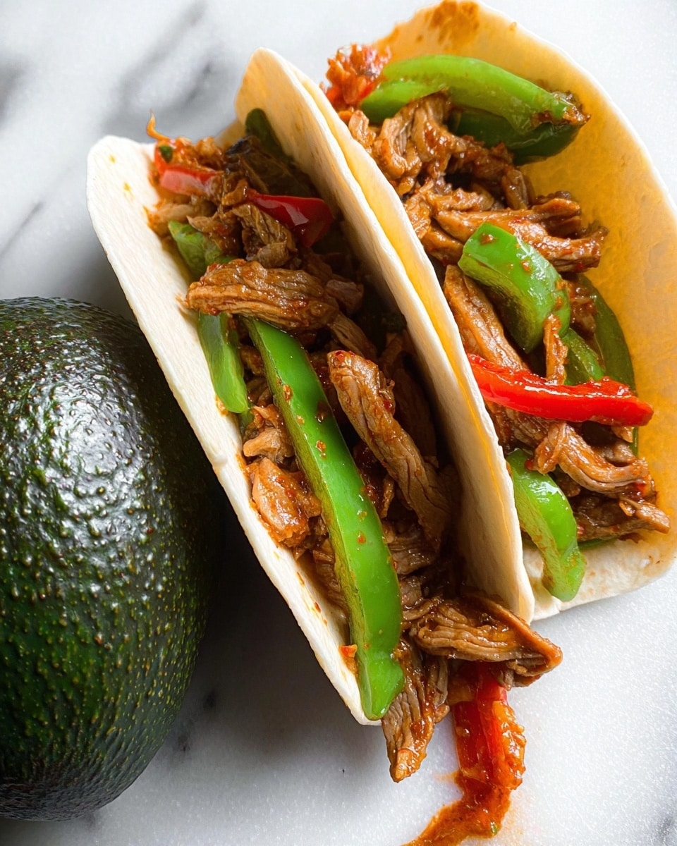 The image shows two soft flour tortillas filled with thin strips of cooked brown meat mixed with green bell pepper slices and small pieces of red pepper. The tortillas are placed side by side on a white marbled surface. To the left of the tortillas, there is a whole dark green avocado with textured skin. Some of the meat filling slightly spills over the edge of the tortilla on the right. The colors focus on the warm brown of the meat, the bright green of the pepper, the red pepper spots, and the neutral light color of the tortillas. The lighting highlights the juicy texture of the meat and vegetables. photo taken with an iphone --ar 4:5 --v 7