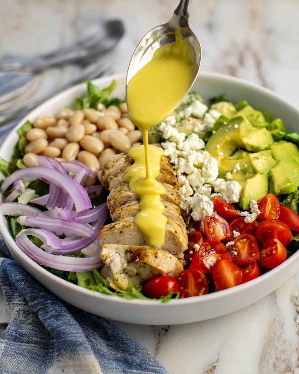 The image shows a clear glass bowl filled with a smooth, creamy yellow mustard sauce sprinkled with small spots of a reddish-brown spice on top. Behind it, there is a white plate with blue stripes holding several golden brown breaded chicken tenders, textured and slightly crispy, scattered with some green herbs. To the right, there is a bunch of vibrant green parsley adding fresh color, all set on a white marbled surface. The photo taken with an iphone --ar 4:5 --v 7