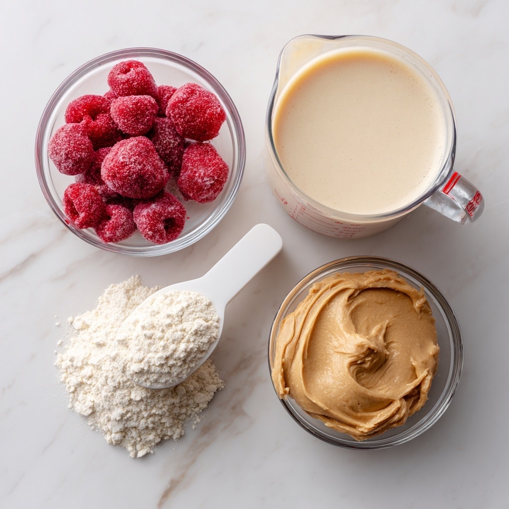 The image shows four separate ingredients on a white marbled surface. At the top right, there is a clear measuring cup filled with light beige almond milk. Below it, slightly to the left, is a small clear bowl containing bright red frozen strawberries with a frosty texture. Near the bottom left, there is a white scoop filled with off-white vanilla protein powder. To the right of the scoop, a small clear bowl holds smooth, light brown peanut butter. Each ingredient is labeled with black text and arrows pointing to them. photo taken with an iphone --ar 4:5 --v 7