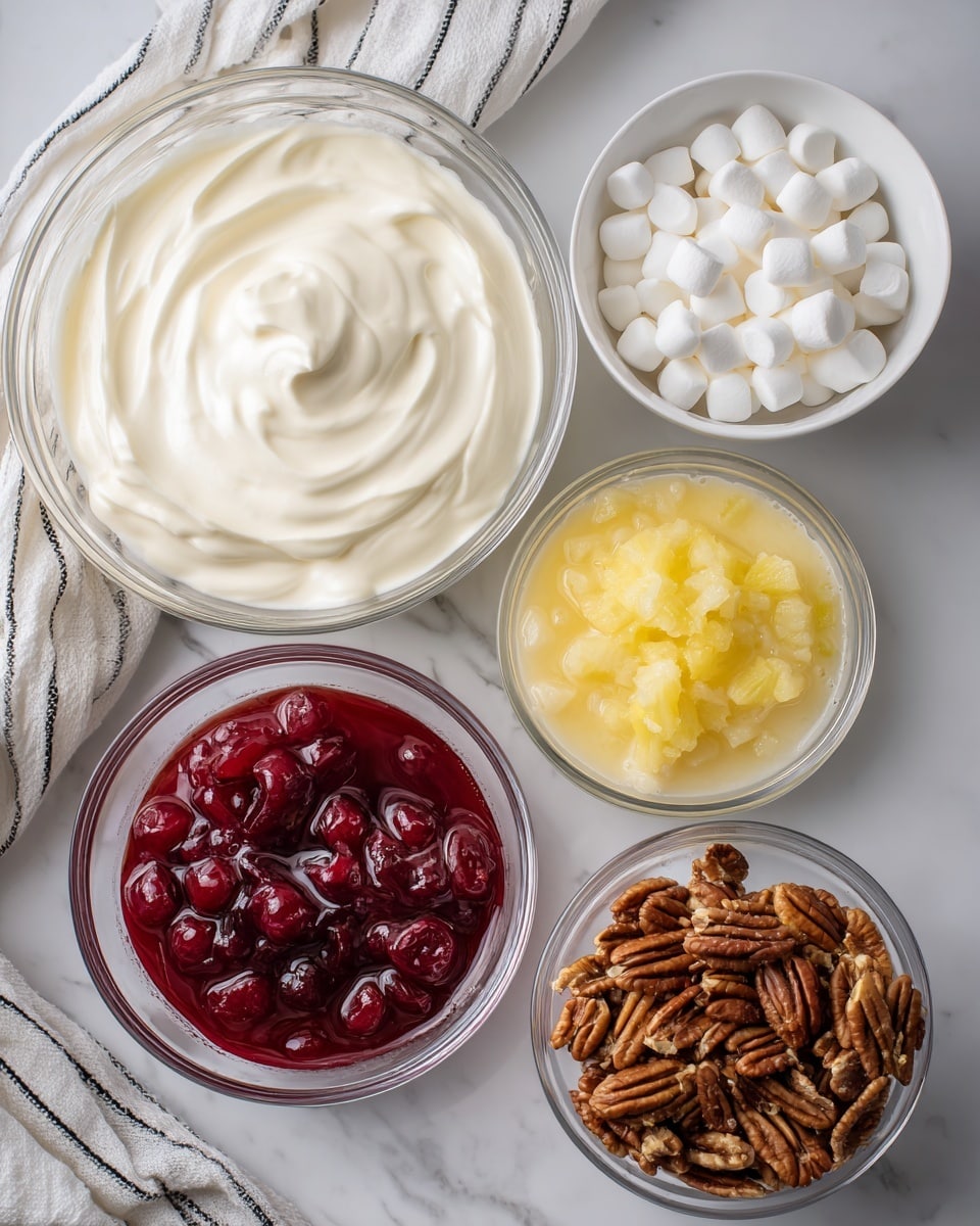 The image shows six bowls placed on a white marbled surface near a white cloth with black stripes. At the top left is a large glass bowl filled with thick white cream showing soft textures and peaks. To the right of it is a white bowl filled with small white mini marshmallows that have a soft, fluffy look. Below the cream is a glass bowl with shiny red cherry pie filling, where whole cherries are visible in the thick syrup. Next to it, towards the right, is a glass bowl with yellow crushed pineapple, showing small wet pieces and texture. Below the pineapple is a glass bowl with smooth, light beige sweetened condensed milk. Lastly, at the bottom right is a glass bowl filled with whole pecan nuts, with clear brown ridges and texture. Photo taken with an iphone --ar 4:5 --v 7