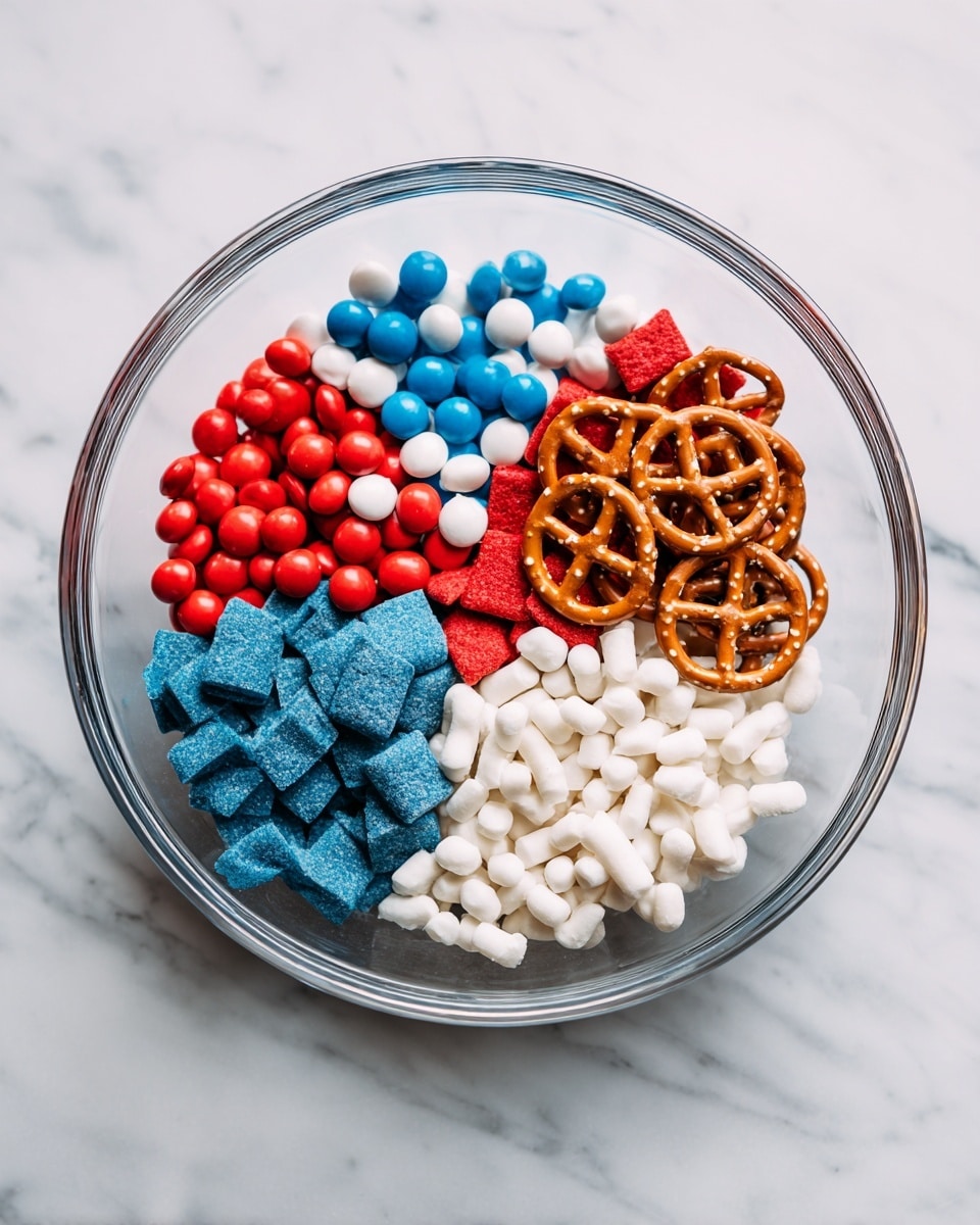 A clear glass bowl on a white marbled surface holds five separate piles of colorful snack items. On the left side, there are small round candies in red, blue, and white. Next to them, there are blue square-shaped pieces with a powdery texture. Below them, white pretzel shapes are placed. To the right of the pretzels, there are red square-shaped pieces similar in texture to the blue ones. Finally, on the bottom right are small white coated candy pieces. The different colors and shapes are arranged side-by-side in the glass bowl for visual contrast. photo taken with an iphone --ar 4:5 --v 7
