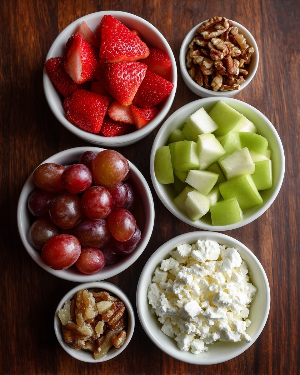 The image shows five small white bowls arranged on a dark brown wooden surface. Each bowl contains a different food item: one bowl is full of quartered red strawberries, another contains halved red grapes with shiny skins, the third holds chunks of green apple with pale flesh, the fourth is filled with small brown candied nuts, and the fifth has crumbled white cheese. The bowls are placed in a somewhat circular pattern, with the strawberries and grapes on opposite sides, and the apple and nuts nearby, making a colorful and fresh mix. Photo taken with an iphone --ar 4:5 --v 7