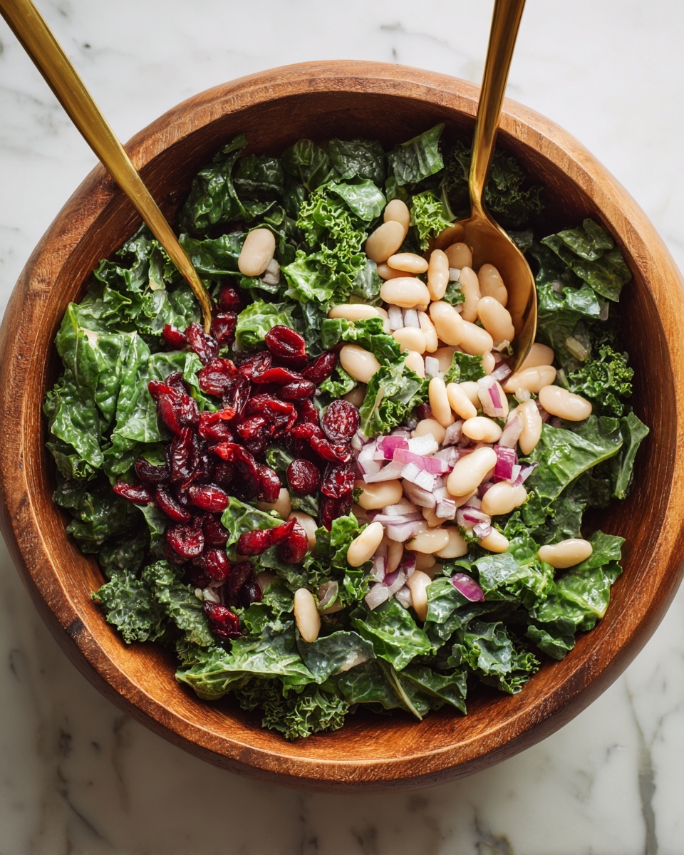 A wooden bowl filled with a colorful salad featuring four main layers: a base of chopped dark green kale, topped with scattered chopped purple onions, bright red dried cranberries, and light brown walnut pieces. On one side, there is a pile of white beans with a light coating of pepper and sauce. Creamy yellow dressing with visible black pepper specks is drizzled unevenly over the salad. A gold spoon rests inside the bowl, partially buried in the ingredients. In the background, there is a small white plate holding more dried cranberries, all placed on a white marbled surface. Photo taken with an iphone --ar 4:5 --v 7