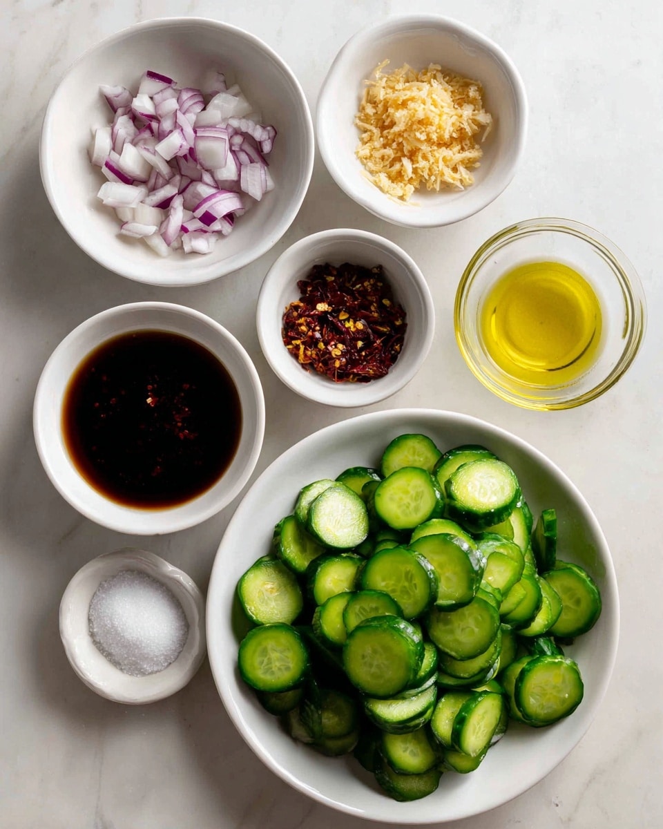 A white plate at the bottom right is full of green sliced cucumbers with a curved shape and darker green skin; above it, six small white bowls are arranged across a white marbled surface, each holding different ingredients: the top left bowl has chopped white and purple onions, the top middle bowl holds finely grated light tan ginger, the top right bowl has small white sesame seeds, below the onions there is a bowl with dark red chili flakes, under it a small bowl contains dark soy sauce, at the bottom left a bowl of white granulated salt, next to it on the right a bowl with minced golden ginger, and above that a transparent bowl with golden yellow liquid, possibly oil, all arranged neatly and brightly lit photo taken with an iphone --ar 4:5 --v 7
