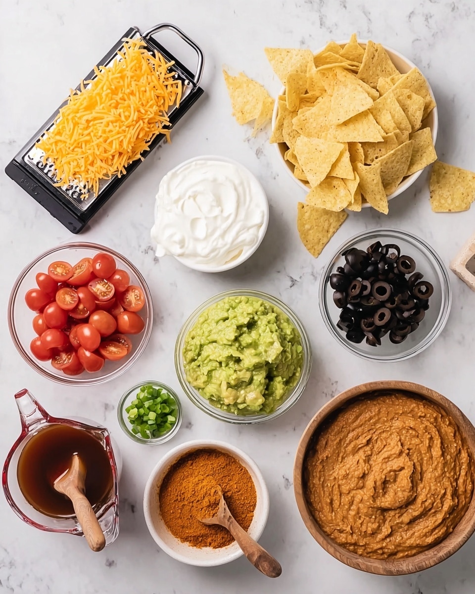 The image shows a top-down view of various ingredients for a dish arranged neatly on a white marbled surface. Starting from the top left, there is a black grater with a block of orange shredded cheese resting on it. Moving clockwise, there is a small white bowl filled with thick white sour cream, beside it a glass bowl holds smooth green guacamole. Next to the guacamole is a pile of light yellow tortilla chips, with a small white bowl of sliced black olives to the right. Below the olives is another small white bowl filled with halved red cherry tomatoes. Next, a wooden bowl contains a mound of orange-brown taco seasoning powder with a small wooden spoon resting in it. To the left, a clear glass measuring cup is filled with dark reddish-brown sauce, and above it is a small white bowl with finely chopped green onions. In the center of the arrangement is a white bowl filled with chunky light brown refried beans. Near the top center, a small glass container holds a small amount of reddish-brown salsa. The entire presentation is clean and colorful. Photo taken with an iphone --ar 4:5 --v 7