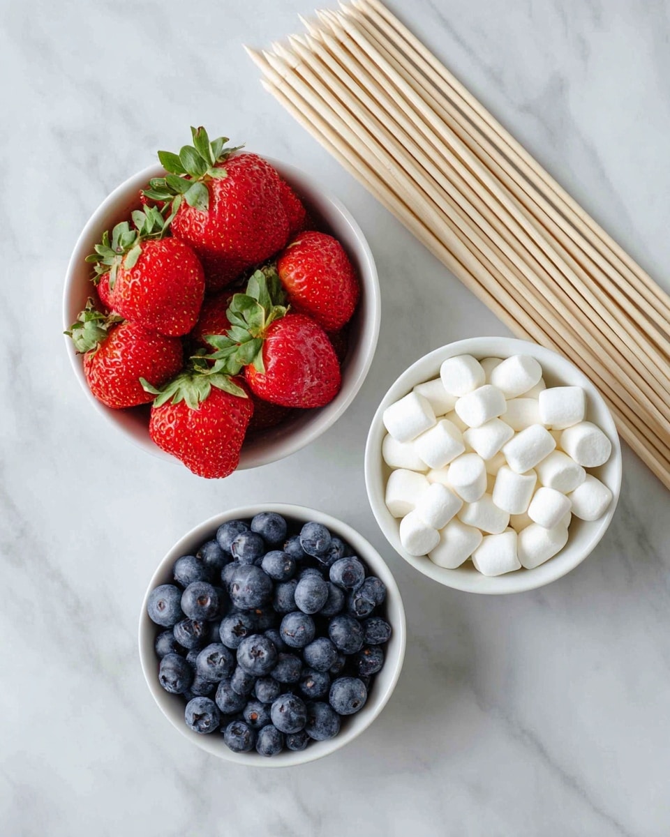 Three small white bowls are placed on a white marbled surface, each filled with a different item: the top left bowl holds bright red strawberries with green leaves, the top right bowl is filled with dark blue blueberries, and the bottom bowl contains small white mini marshmallows. To the right of the bowls, there is a neat bundle of light wooden skewers placed side by side, all aligned in a diagonal position. The scene is well lit, showing the fresh colors and textures clearly. photo taken with an iphone --ar 4:5 --v 7
