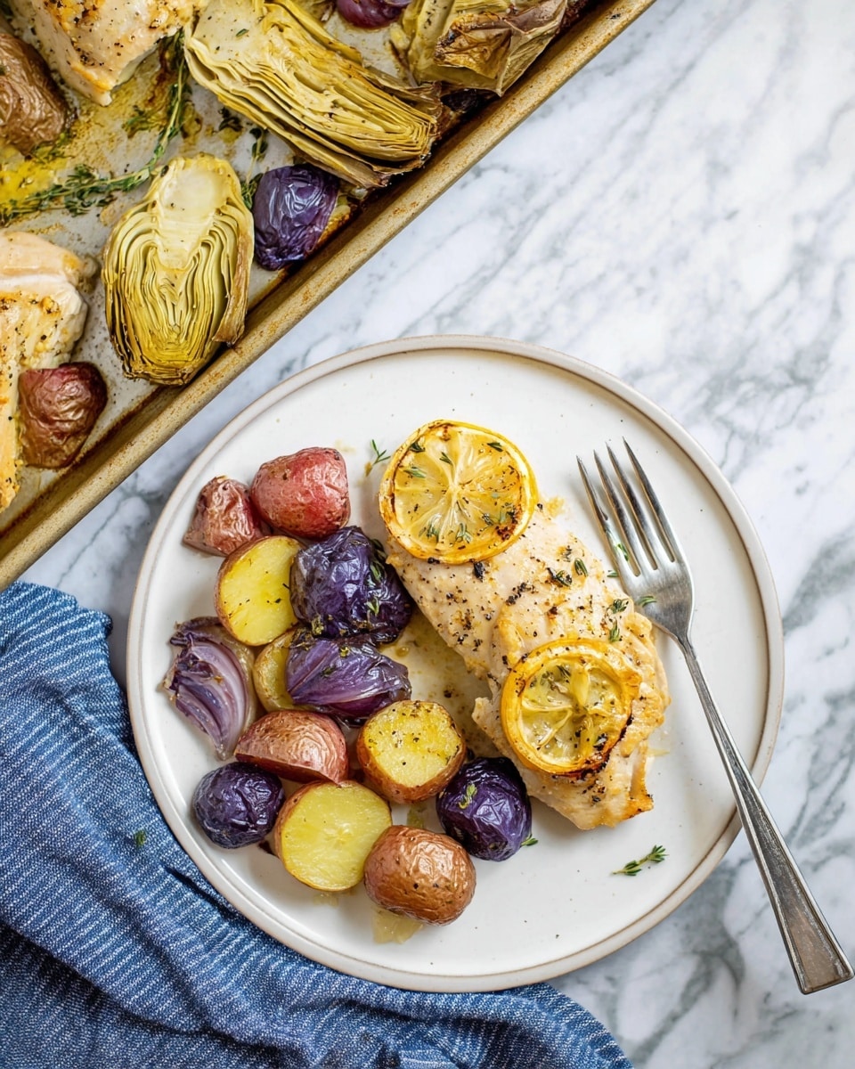 The image shows a white plate with a simple meal consisting of three main layers: at the bottom, there are scattered roasted small potatoes in mixed colors of purple, red, and yellow with a wrinkled texture; on the left side, roasted artichoke layers with a slightly crispy edge and pale green-yellow tones; on top, there's a piece of roasted chicken with light golden skin and black pepper specks, garnished with a single slice of charred lemon and a small sprig of thyme. A silver fork rests on the right edge of the plate, partly touching the potatoes. In the background, a baking tray with similar roasted chicken, artichokes, potatoes, and lemon slices sits on a white marbled surface. A blue and white striped cloth is partially visible under the plate. The photo taken with an iphone --ar 4:5 --v 7