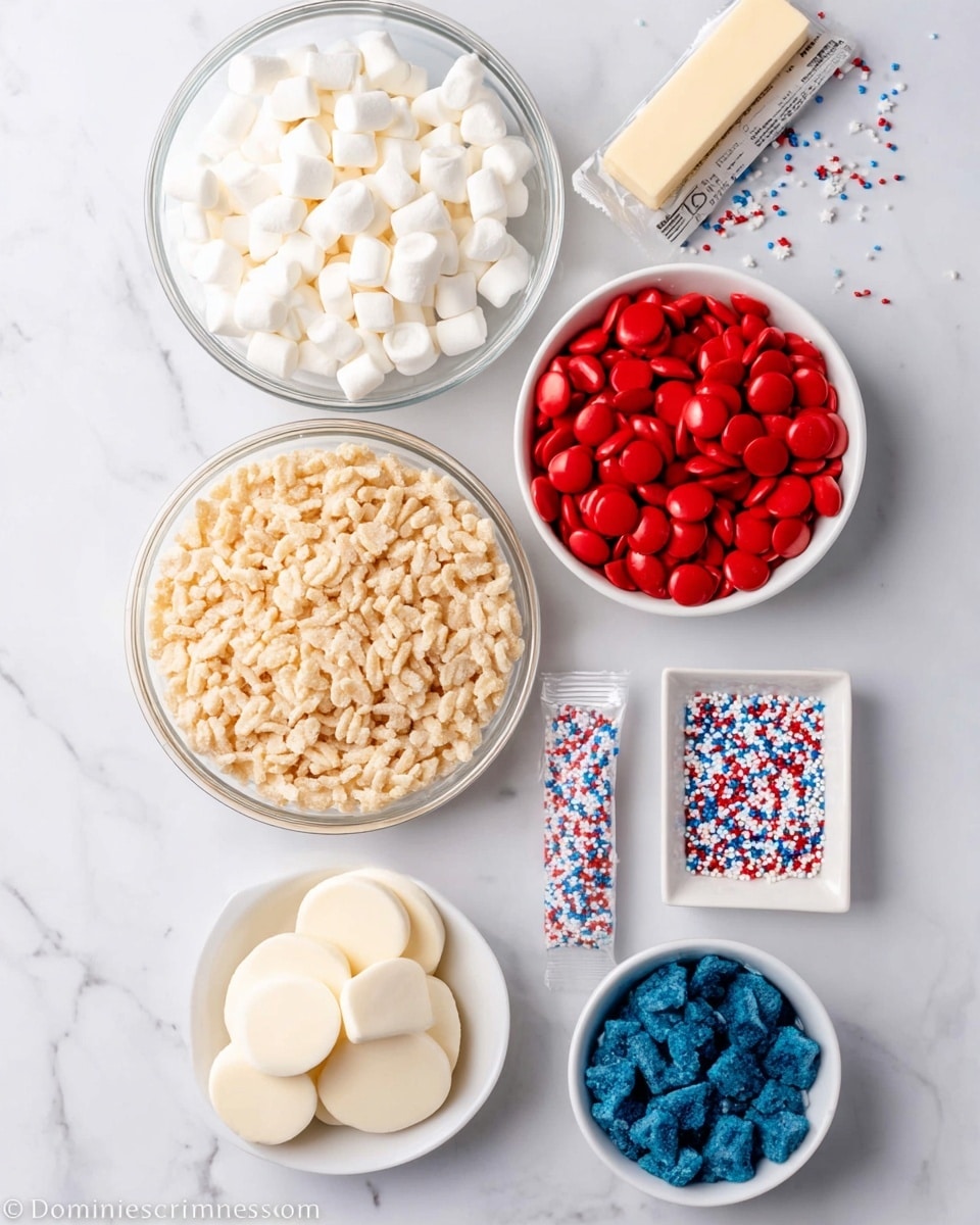 The image shows six bowls and containers on a white marbled surface. The largest clear glass bowl at the bottom center holds light beige puffed rice cereal with a slightly rough texture. Above it to the left is another clear glass bowl filled with small, white, soft mini marshmallows. To the right of the marshmallows is a white bowl full of bright red candy melts, smooth and round like discs. Below this red bowl, near the center right, is a small white square dish containing small red, white, and blue star-shaped sprinkles. Under the sprinkle dish is a small stick of light tan butter wrapped in paper with visible text. At the bottom left is another white bowl with smooth, flat white candy melts shaped like discs. At the bottom right is a white bowl holding blue candy melts with a marbled texture similar to the red candy melts. There are small scattered sprinkles and cereal pieces on the white marbled surface. Photo taken with an iphone --ar 4:5 --v 7
