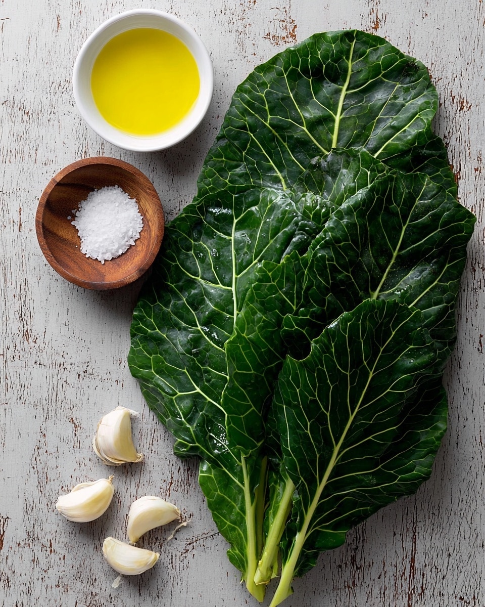 A bunch of dark green collard greens with visible veins lies on the right side on a white marbled texture. To the upper left of the greens, there is a small white bowl filled with bright yellow olive oil. Below the bowl, there is a small wooden bowl filled with coarse white salt. At the bottom left corner, there are five garlic cloves scattered loosely. The background is a textured white marbled surface. The dish is shown with natural light and has a clean, fresh look. Photo taken with an iphone --ar 4:5 --v 7