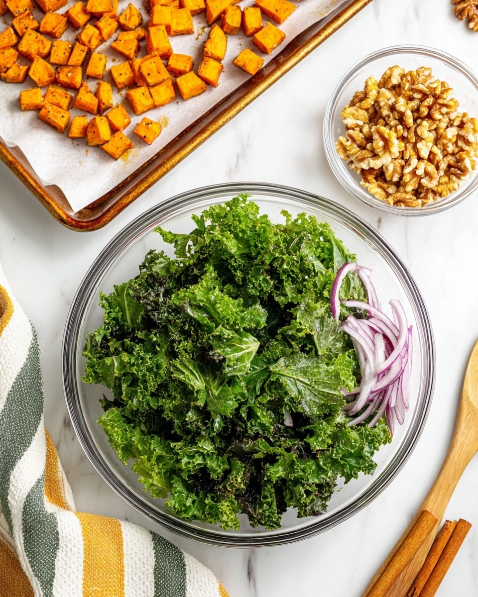 The image shows a clear glass bowl filled with fresh, green kale leaves mixed with thin slices of purple onion at the bottom right on a white marbled surface. To the top left, there is a white baking tray lined with paper, holding roasted cubed orange sweet potatoes with a slightly browned texture. Near the top right is a small clear glass bowl filled with chopped light brown walnuts, and next to it are three cinnamon sticks placed diagonally. A striped cloth with white, yellow, green, and blue lines is visible at the bottom left corner. Photo taken with an iphone --ar 4:5 --v 7