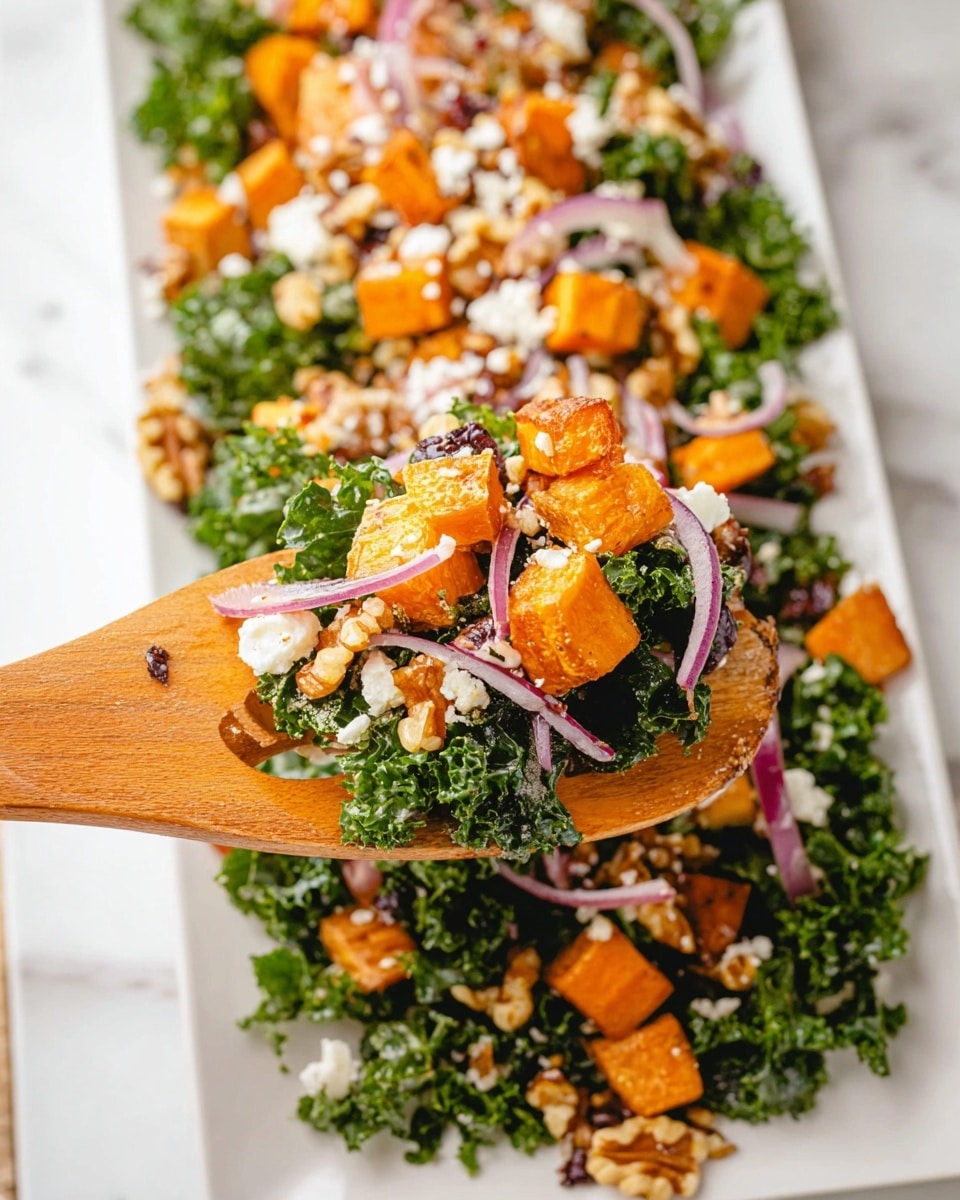 A white rectangular plate holds a colorful salad layered with curly green kale as the base. On top, there are bright orange roasted cubes evenly spread, mixed with thin slices of purple onion. Scattered over the salad are small pieces of white cheese and crushed walnuts, adding texture and creaminess. In the foreground, a pair of wooden salad tongs holds a serving of the salad, showing the fresh green leaves, orange cubes, purple onion, white cheese crumbles, and walnut pieces clearly. The background is a white marbled surface. Photo taken with an iphone --ar 4:5 --v 7