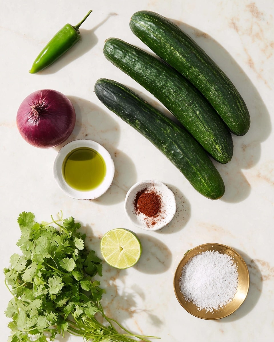 The image shows fresh ingredients arranged neatly on a white marbled surface. There are two long, dark green cucumbers placed diagonally, a whole deep purple onion, and a green jalapeño pepper near the top. A bunch of green cilantro leaves is set on the left side. In the center, a white small dish holds green olive oil, and next to it, another white small dish contains a red spice powder. A half lime with a pale yellow-green color is placed near the middle right. A gold plate at the bottom right holds white coarse salt. The ingredients are spaced out evenly with bright natural light casting soft shadows. Photo taken with an iphone --ar 4:5 --v 7