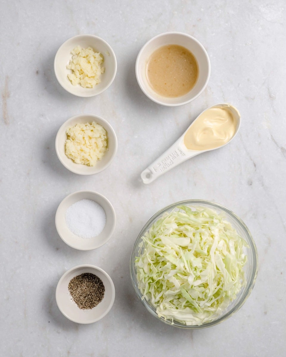 The image shows six small white bowls and a white measuring spoon arranged on a white marbled surface. In the bottom right corner, a clear glass bowl filled with finely shredded pale green and white cabbage is visible. Above it to the left, there is a small white bowl with minced or crushed garlic, creamy-looking and pale yellow. To the right, a clear plastic 1/3 cup measuring spoon holds a pale yellow mayo-like creamy substance. Above that is a small white bowl containing a light brown liquid with a few black specks. Below this liquid bowl is another small white bowl filled with granulated white sugar, and nearer the bottom left corner, two more small white bowls contain salt and ground black pepper, respectively. The arrangement is neat and evenly spaced. Photo taken with an iphone --ar 4:5 --v 7