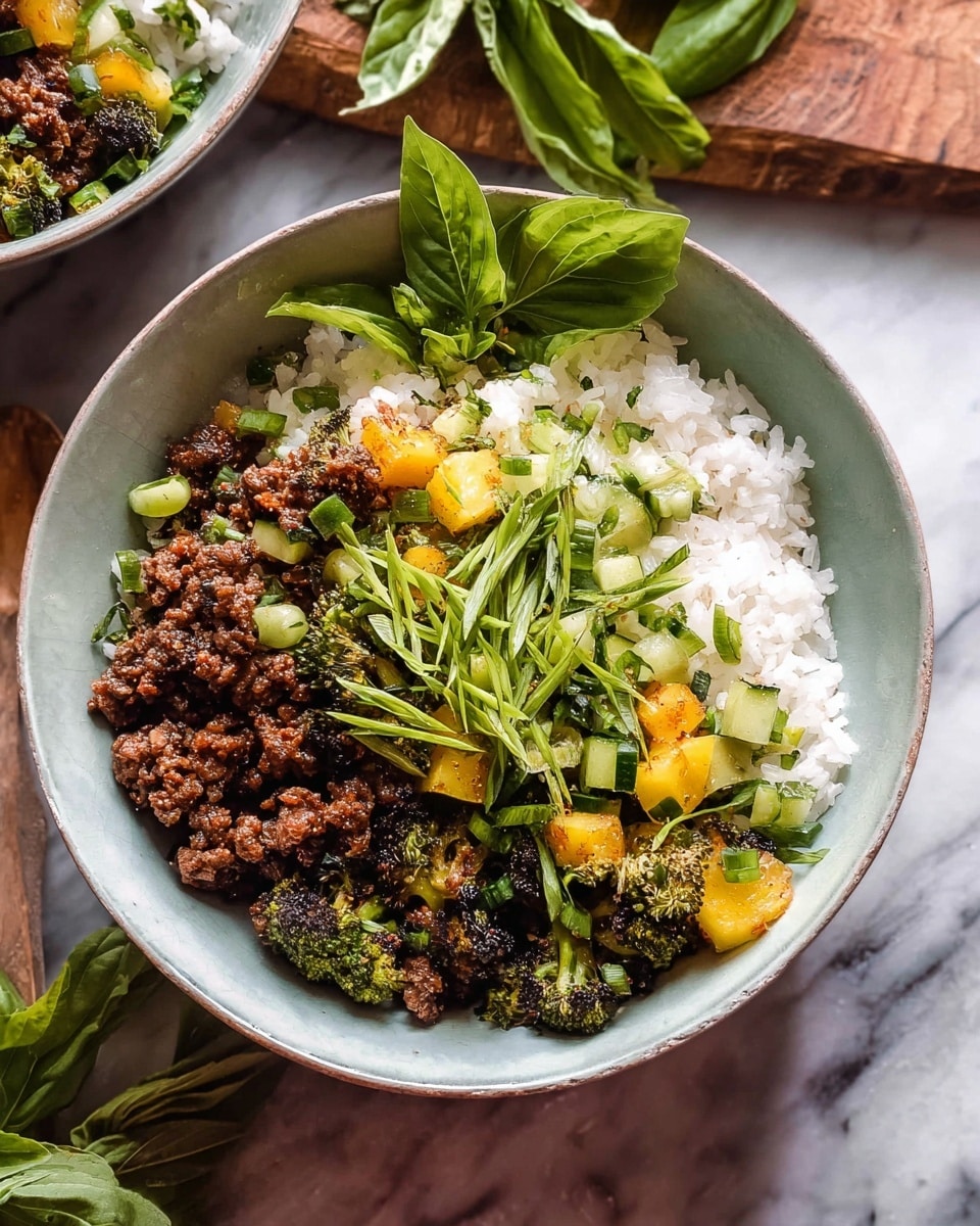 A white bowl is filled with a base layer of white rice. On top, there is a mix of dark brown cooked ground meat pieces and roasted green broccoli florets, along with small bright yellow cubes of pineapple. Scattered on the surface are small diced pieces of fresh green cucumber and chopped herbs. Long, thin green scallion strips are piled on top as the final layer. A few fresh green basil leaves are placed around the bowl's edge. The bowl sits on a white marbled surface with part of another bowl and a wooden board with basil leaves in the background. Photo taken with an iphone --ar 4:5 --v 7