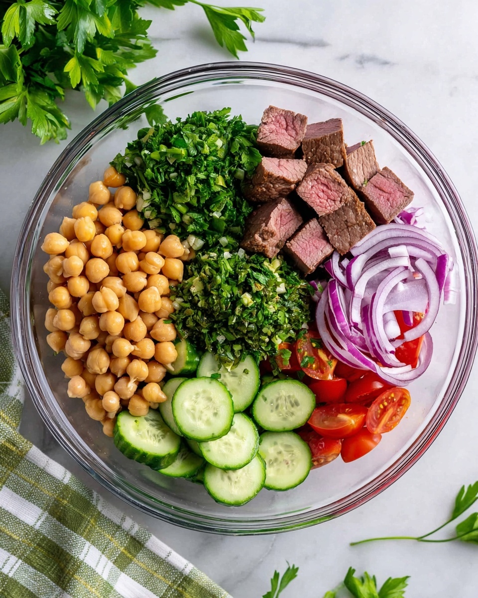A clear glass bowl filled with six layers of fresh ingredients arranged in separate sections. The first layer consists of medium-sized, light brown chickpeas positioned at the bottom left. Above the chickpeas is a layer of finely chopped dark green parsley. Next to the parsley are round slices of bright green cucumber with visible seeds. On top, there are small cubes of lightly browned, medium-rare beef with a pink center. To the right of the beef is a mound of finely chopped green herbs, and below this, slightly overlapping, are thin slices of purple and white onion. The last layer at the bottom right contains small, bright red tomato pieces. The bowl is set on a white marbled surface with some fresh parsley sprigs nearby, and a green and white checked cloth is partially visible on the bottom left. Photo taken with an iphone --ar 4:5 --v 7