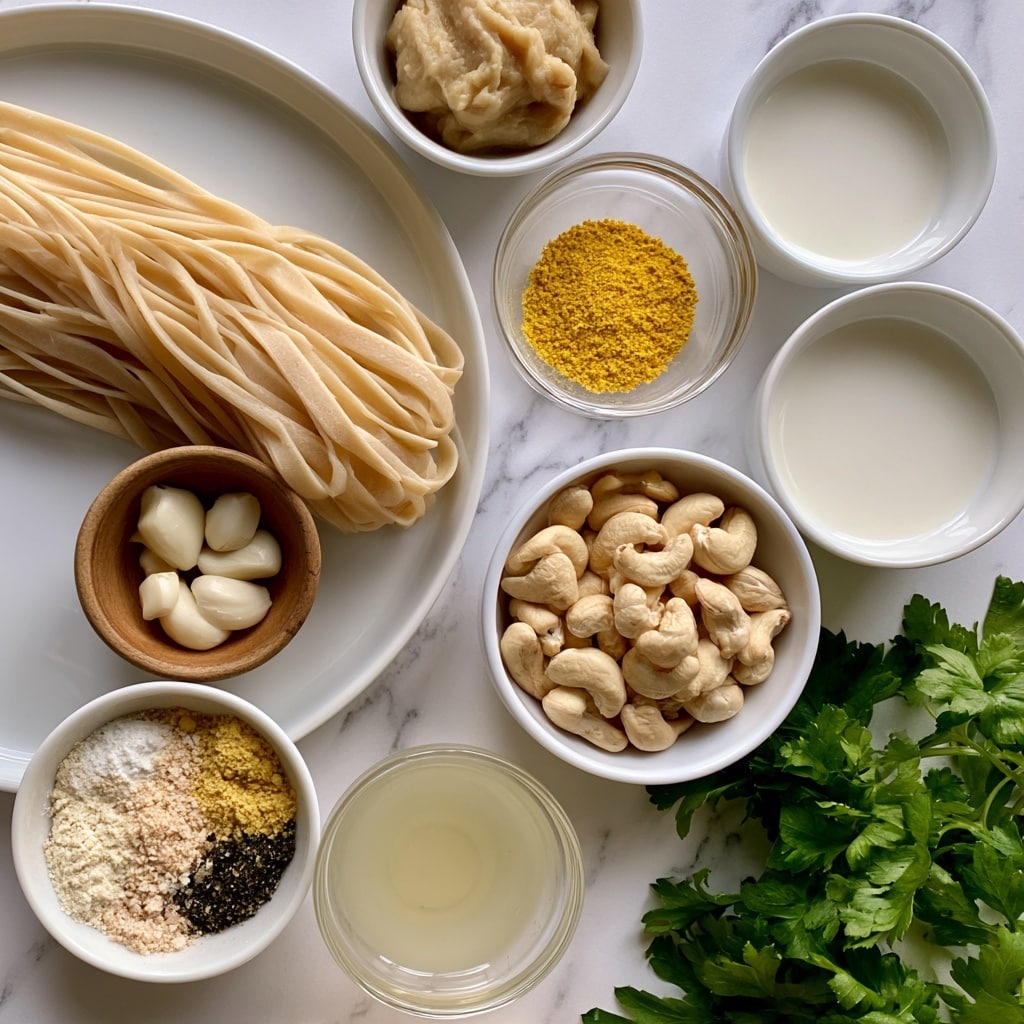 The image shows a top view of several white bowls and plates arranged on a white marbled surface. A large white plate holds a bundle of light beige fettuccine pasta and a small wooden bowl with several white garlic cloves placed near the bottom edge. To the right, a small clear glass bowl contains bright yellow nutritional yeast, and next to it, another small white bowl holds non-dairy milk with a smooth white color. Above them, a small white bowl has mellow white miso paste. Below, a white bowl is filled with light beige cashew nuts. Towards the bottom left, a small white bowl holds a mix of seasoning powders in soft tones of white, beige, yellow, and black. Another small clear bowl contains pale lemon juice. Bright green parsley leaves are arranged in the bottom right corner, adding a touch of color and freshness to the layout. Photo taken with an iphone --ar 4:5 --v 7