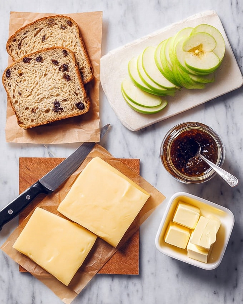 The image shows an arrangement on a white marbled surface with three slices of raisin bread placed on brown paper at the left, below them are two slices of light yellow cheese with smooth texture. To the right, there is a white wooden cutting board holding several bright green apple slices with a sharp black and silver knife resting diagonally across it. Below the cutting board is a small glass jar filled with dark brown jam, a silver spoon inside, and next to it is a white butter dish containing yellow butter with three slices cut. The breakfast items are neatly placed and well lit, photo taken with an iphone --ar 4:5 --v 7