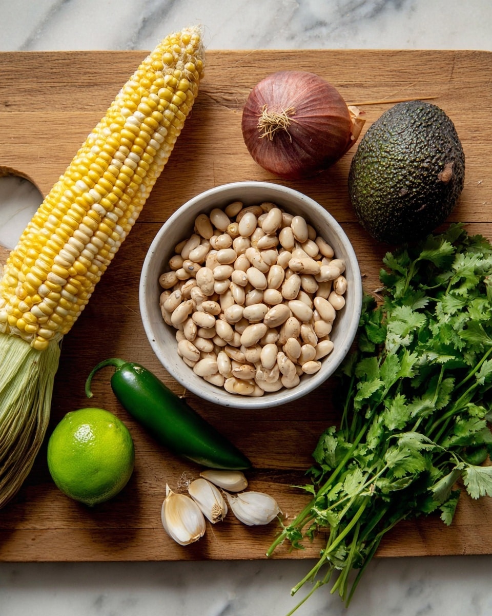 A wooden cutting board holds a white bowl filled with light beige beans positioned on the right side; to the left of the bowl, there is a corn cob with yellow and white kernels, a dark brown avocado, a reddish shallot, a shiny green jalapeño pepper, and three garlic cloves near the bottom center. Toward the bottom right of the board, there is a bright green lime and a bunch of fresh cilantro with leafy green tops and stems spread out. The whole scene rests on a white marbled surface photo taken with an iphone --ar 4:5 --v 7